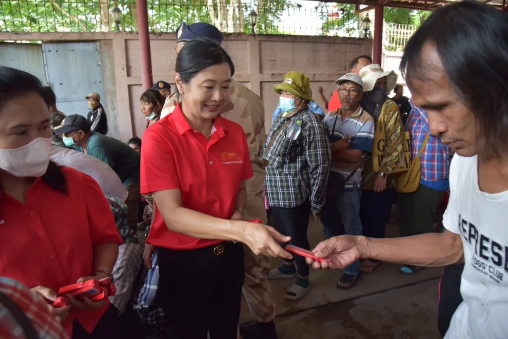 ผู้ร่วมงานรับติ้วจากผู้ปฏิบัติงานในพิธีกระจาดดิน ปี 2568