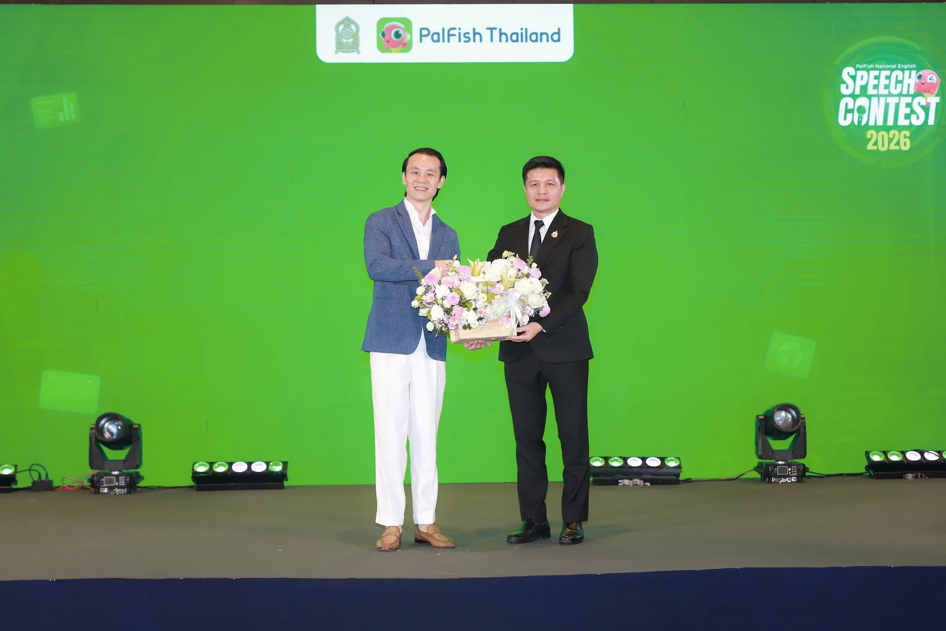 ผู้แทนสองคนมอบช่อดอกไม้บนเวที PalFish National English Speech Contest 2026