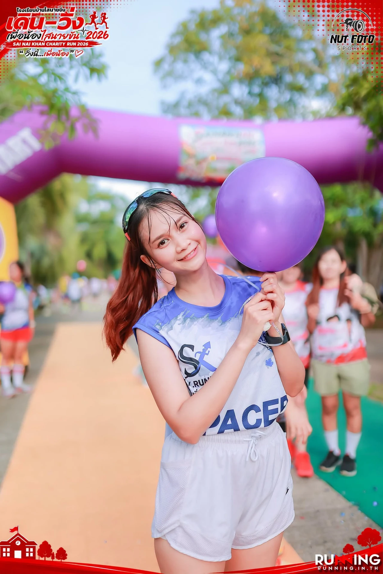ผู้ร่วมกิจกรรมถือบอลลูนในบริเวณงานไสนายขัน 2026 พร้อมเครดิต NUT FOTO SPORTS และ RUNNING.IN.TH