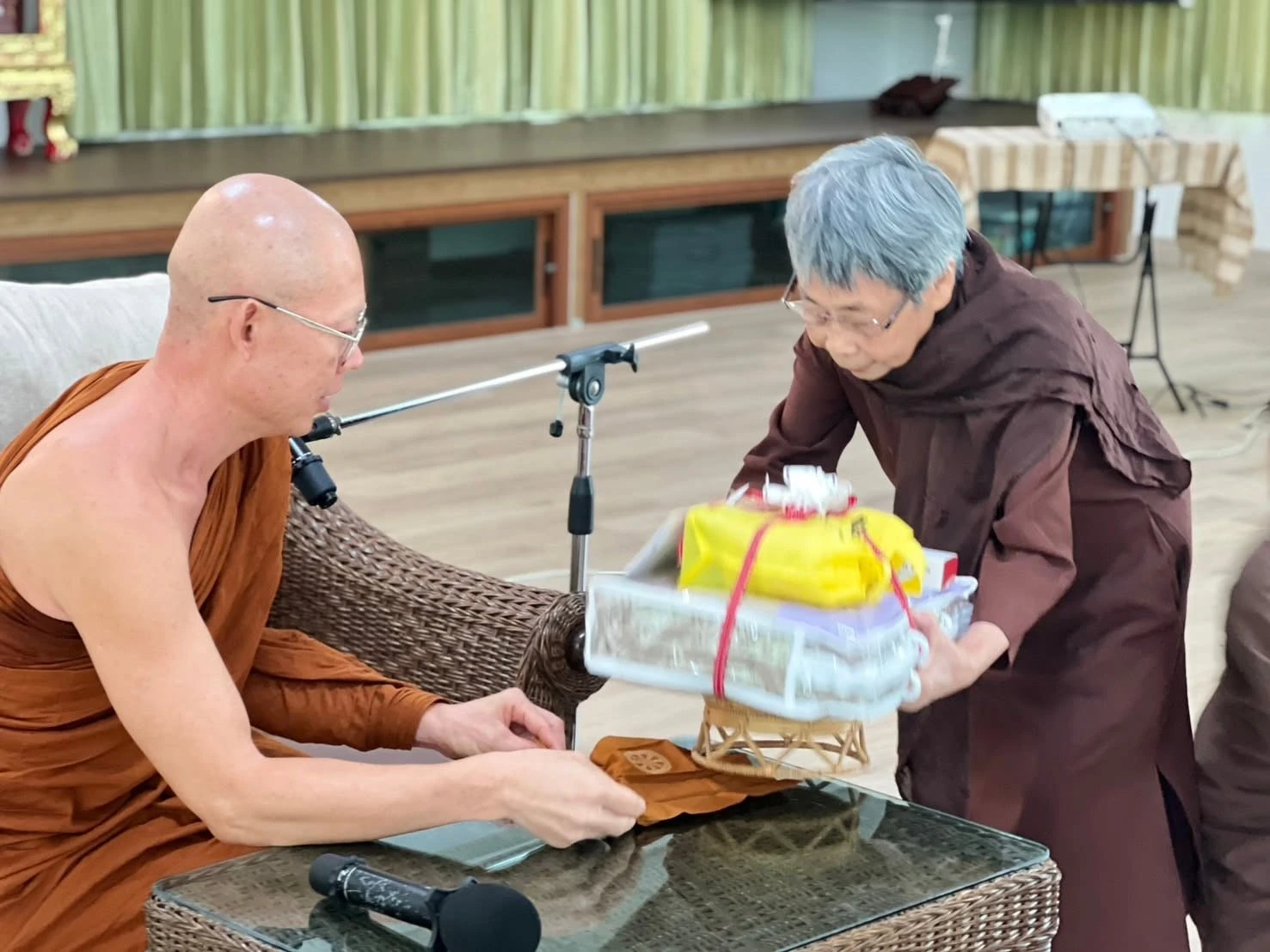 ผู้ร่วมกิจกรรมนำสิ่งของถวายพระภิกษุ จากชุดภาพหลังคอร์สรู้สึกตัวแบบธรรมชาติปี 2568